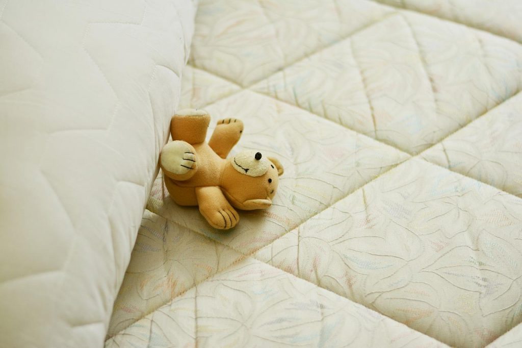 Photo of a teddybear on a mattress