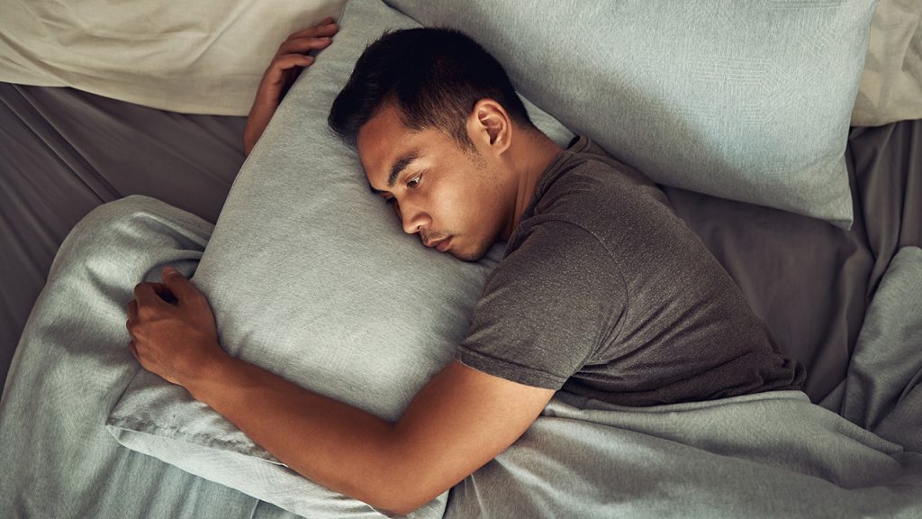 Man laying awake in bed