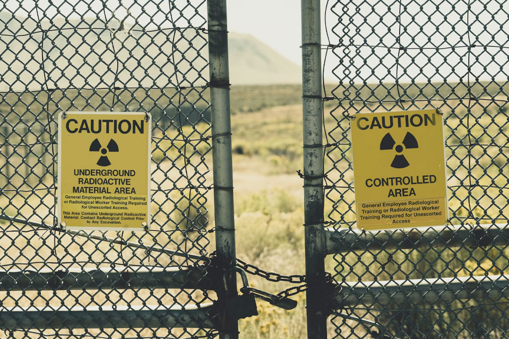 A fence with signs warning against radioactivity