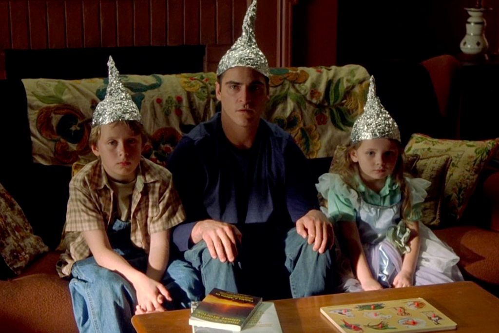 Image from the movie Signs of the family wearing tinfoil hats